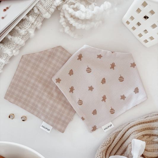 Reversible Dog Bandana on a light surface with cookies and yarn.