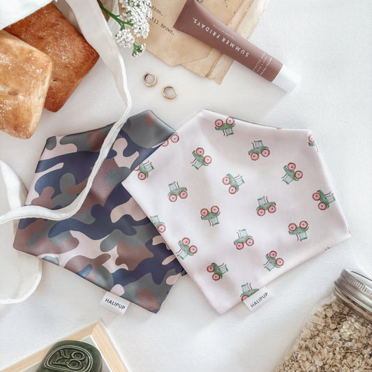 Camo & tractor dog bandanas on a white surface