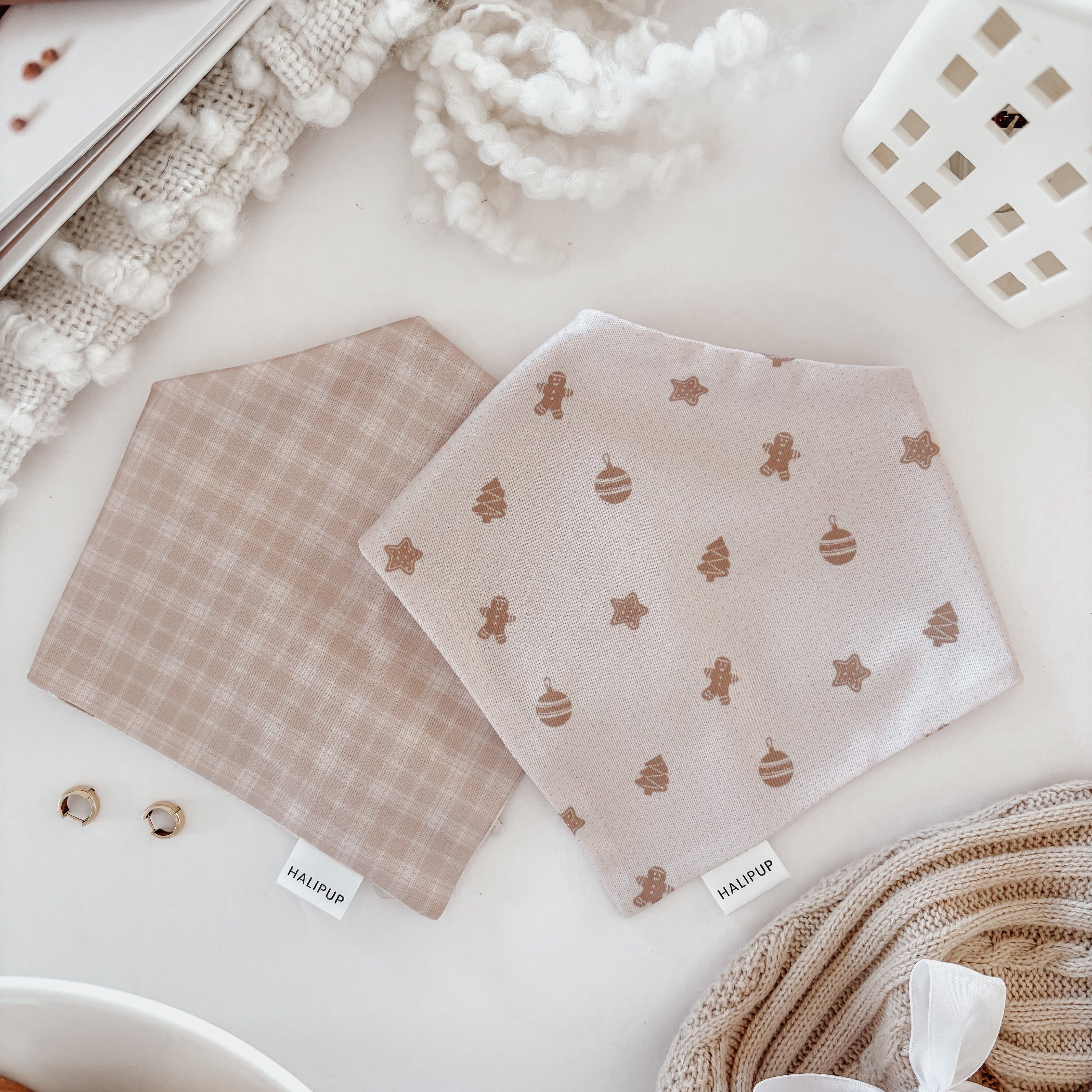 Reversible Dog Bandana on a light surface with cookies and yarn.
