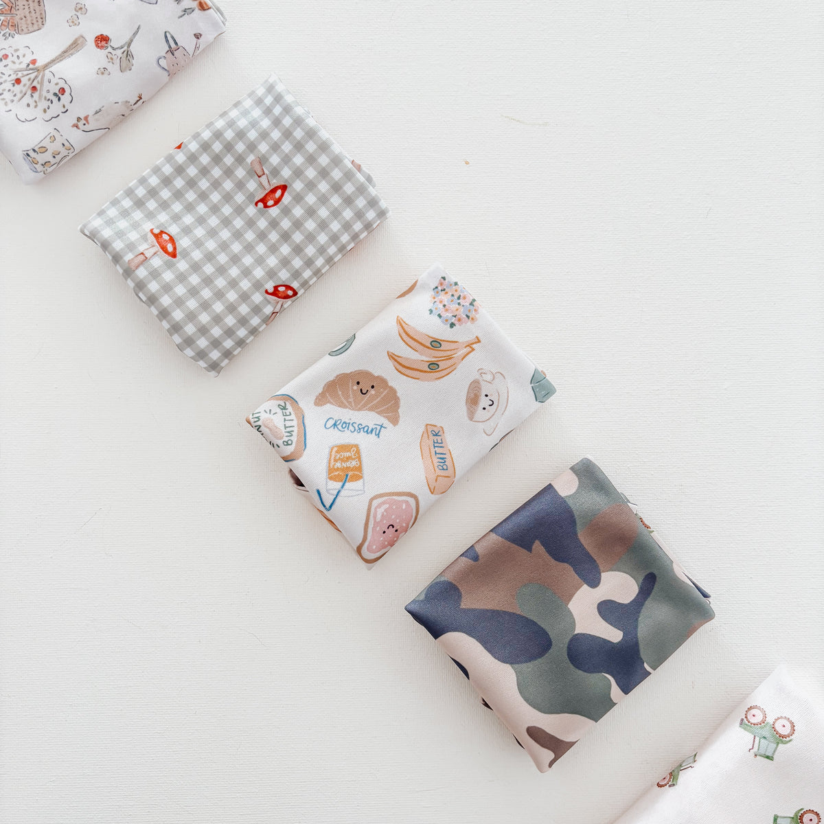 Collection of neutral dog bandanas on a light background